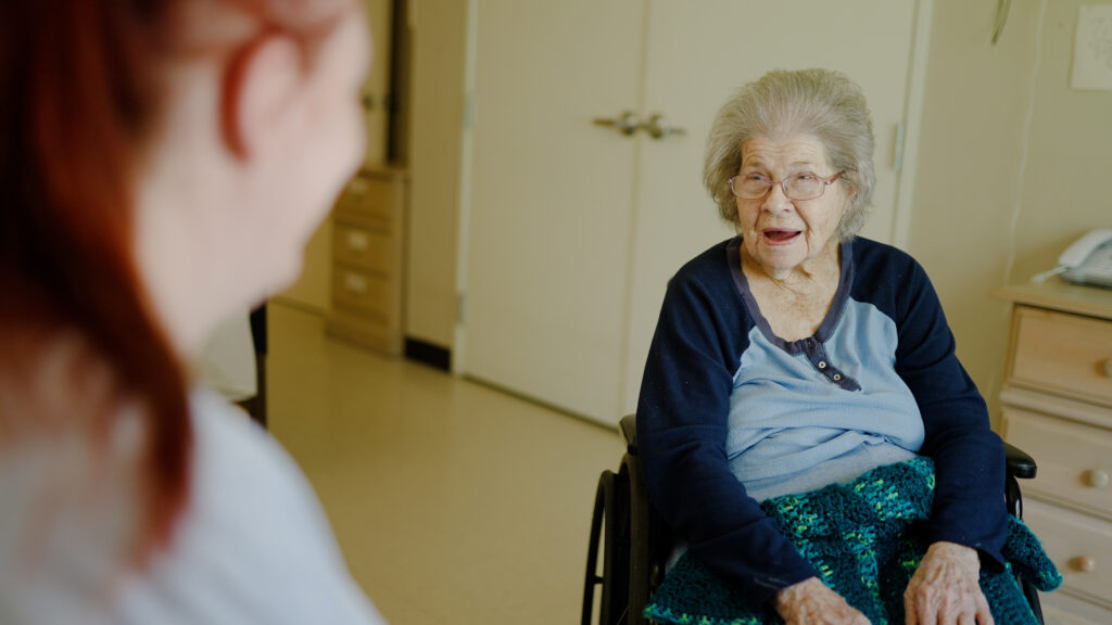 A woman is talking with a nurse at a respite care facility